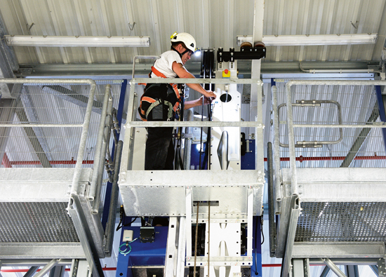 LTW service technician performs maintenance on the stacker crane in the stable maintenance basket